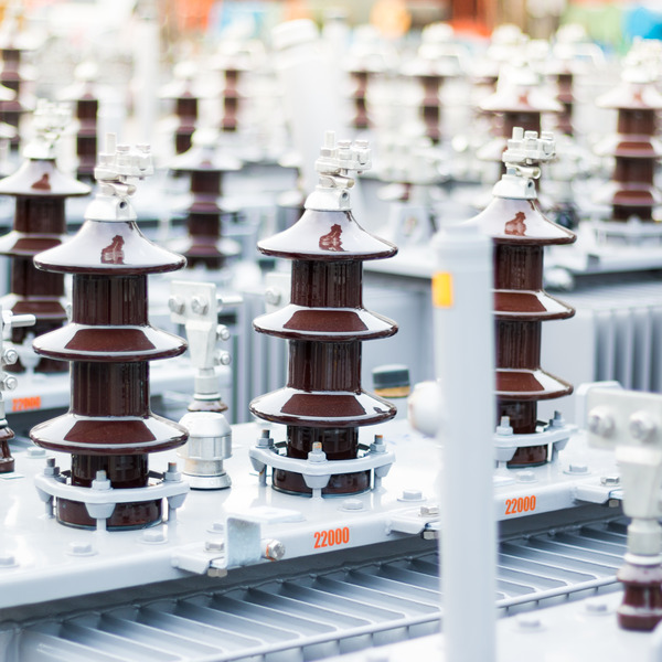 rows of brown porcelain insulators on large gray transformers rows of brown porcelain insulators on large gray transformers